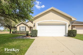 a home with a white garage door and a driveway