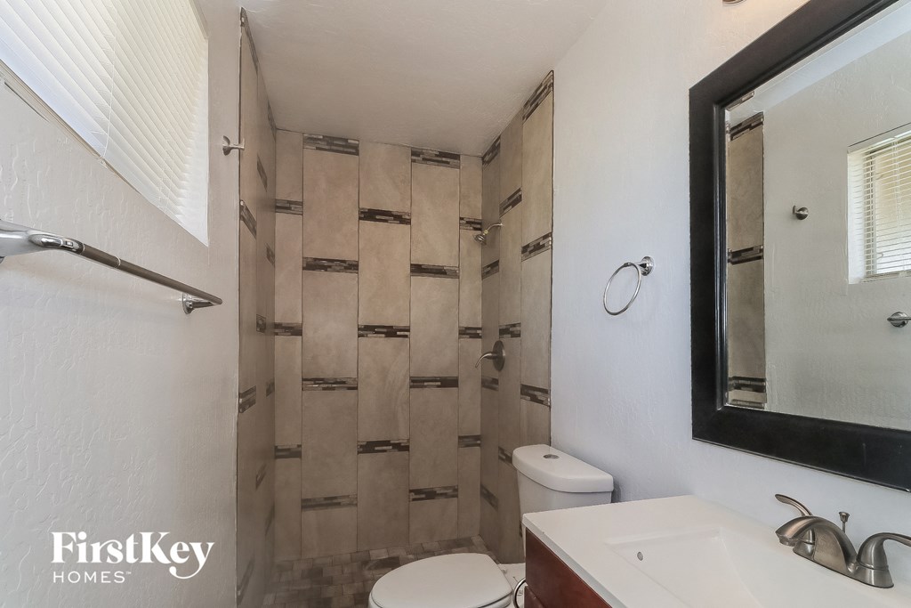 a small bathroom with a shower and a sink and a toilet