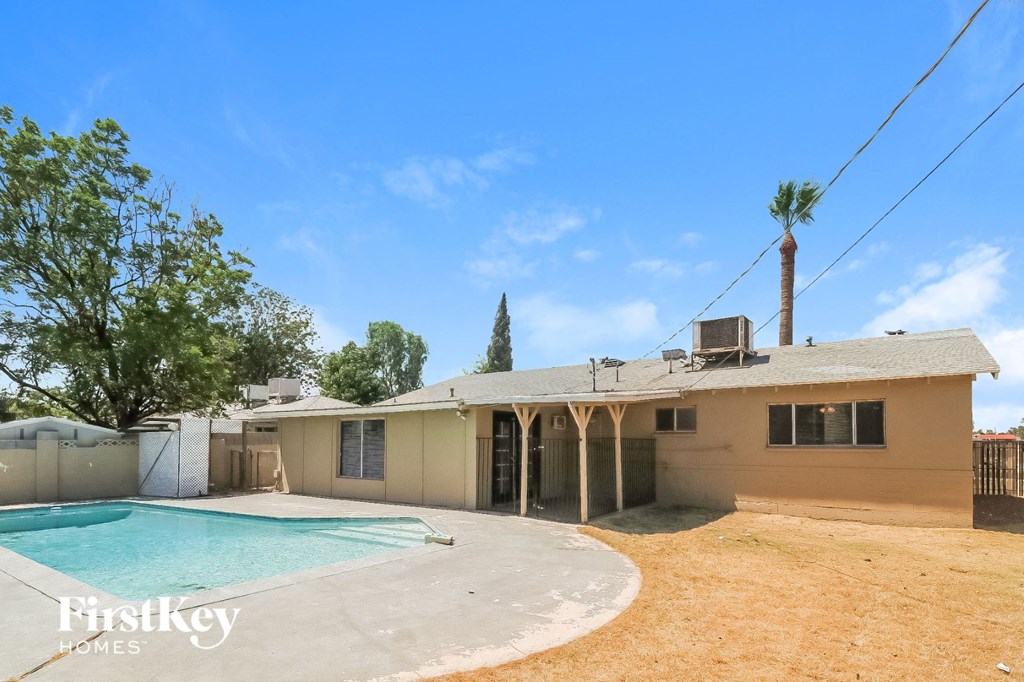 a backyard with a pool and a house
