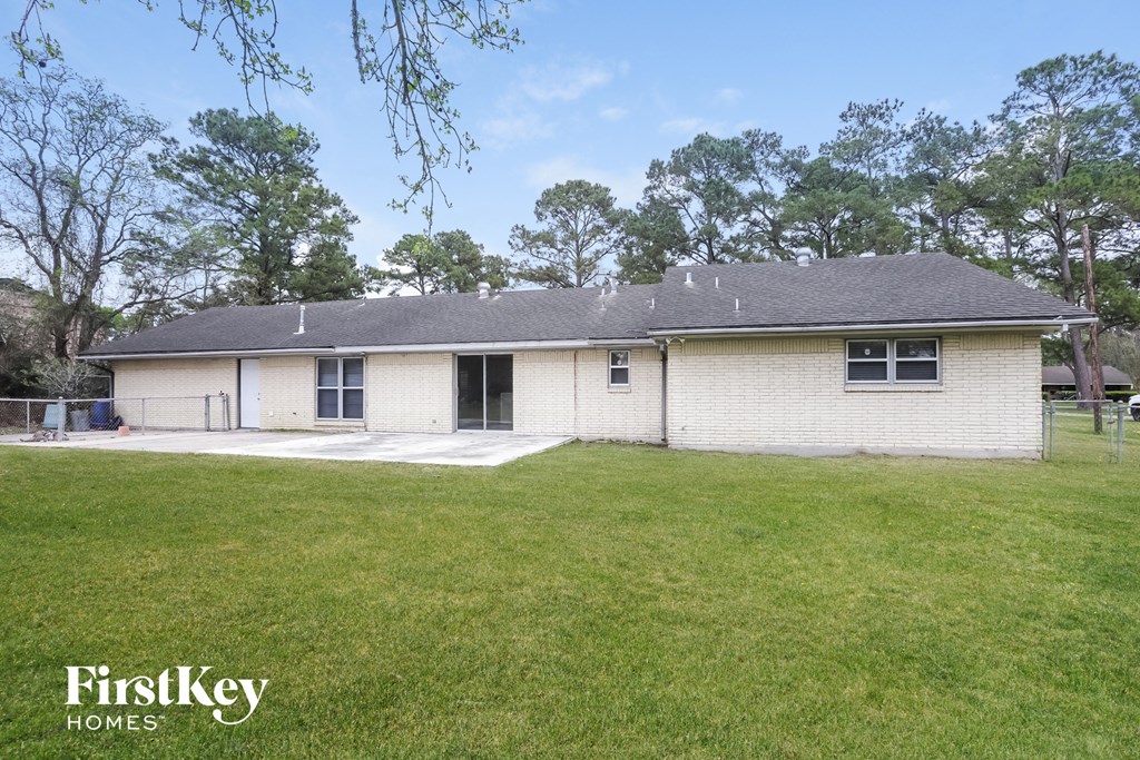 front view of a white brick home with a grassy yard