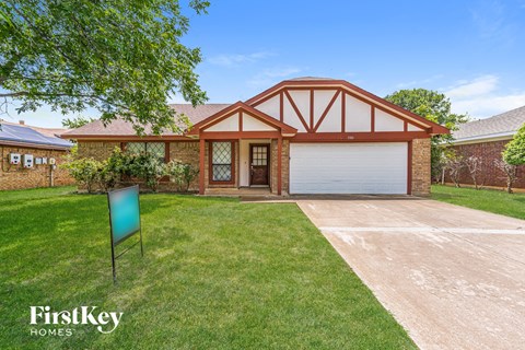a house with a driveway and lawn and a garage door