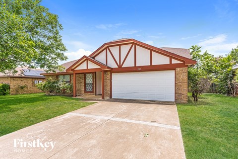 a home with a driveway and a garage door