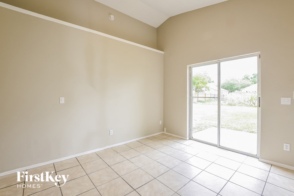 an empty living room with a sliding glass door
