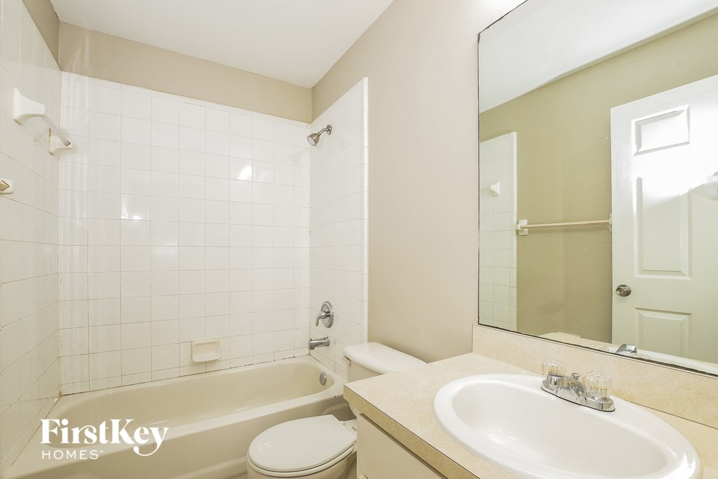 a bathroom with a sink and a toilet and a bath tub