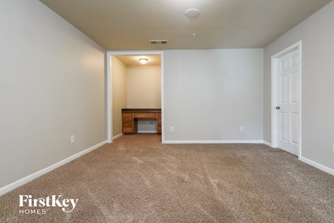 a room with carpet and a table in the corner