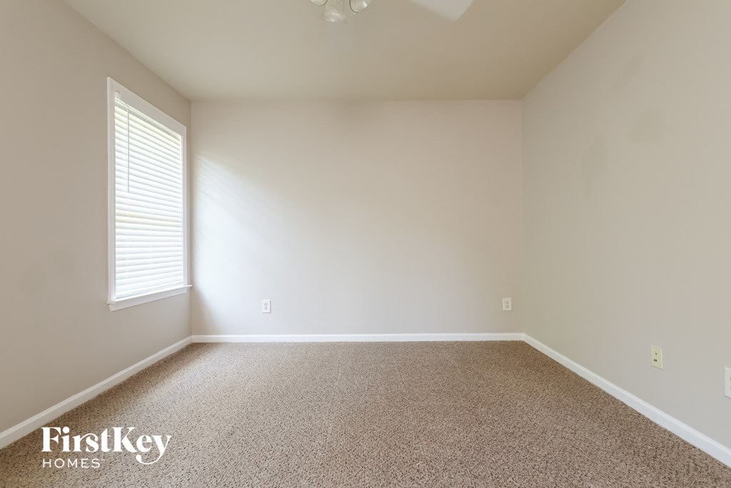 a empty room with white walls and a window