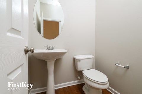 a small bathroom with a sink toilet and a mirror
