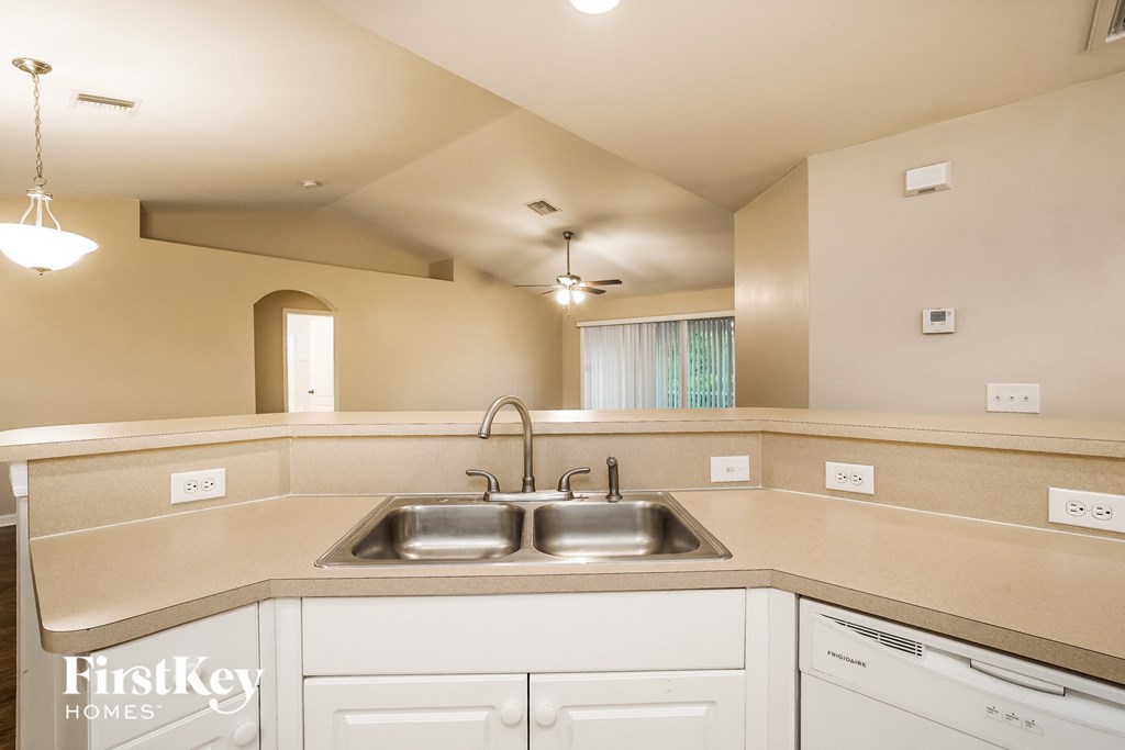 a kitchen with white cabinets and a sink