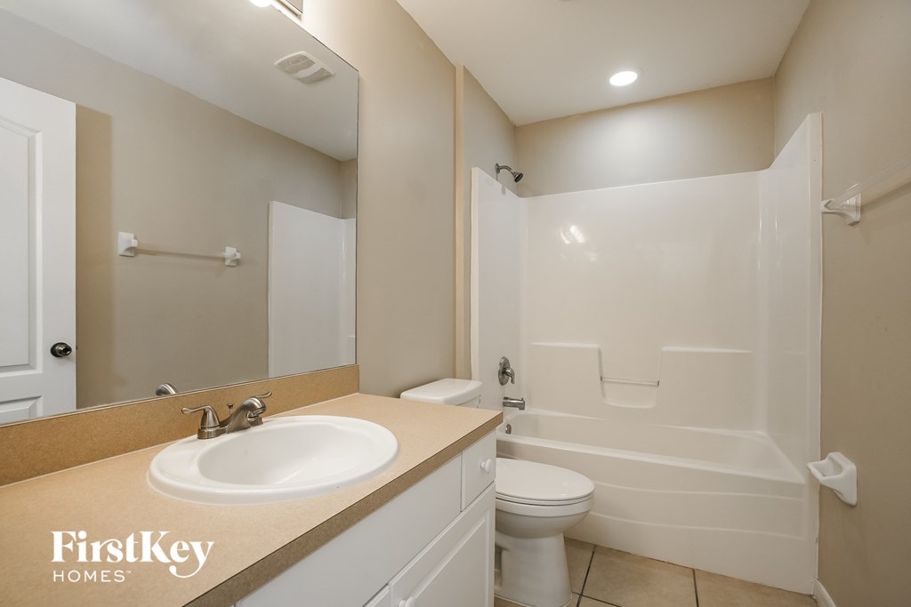 a bathroom with a sink and a toilet and a shower