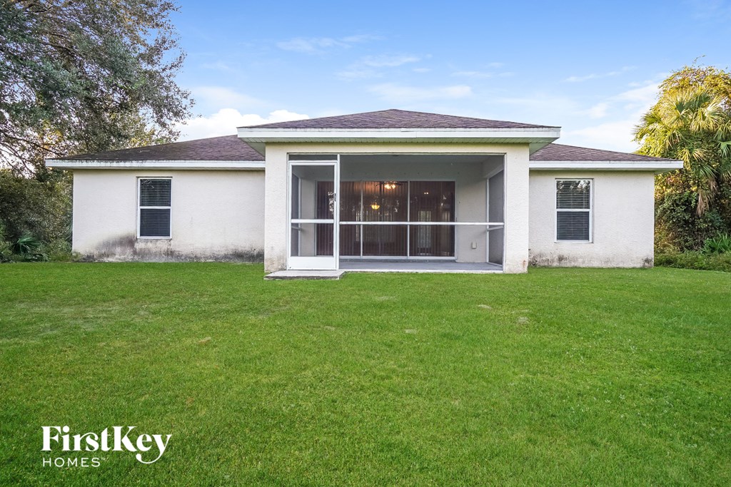 a small white house with a lawn in front of it