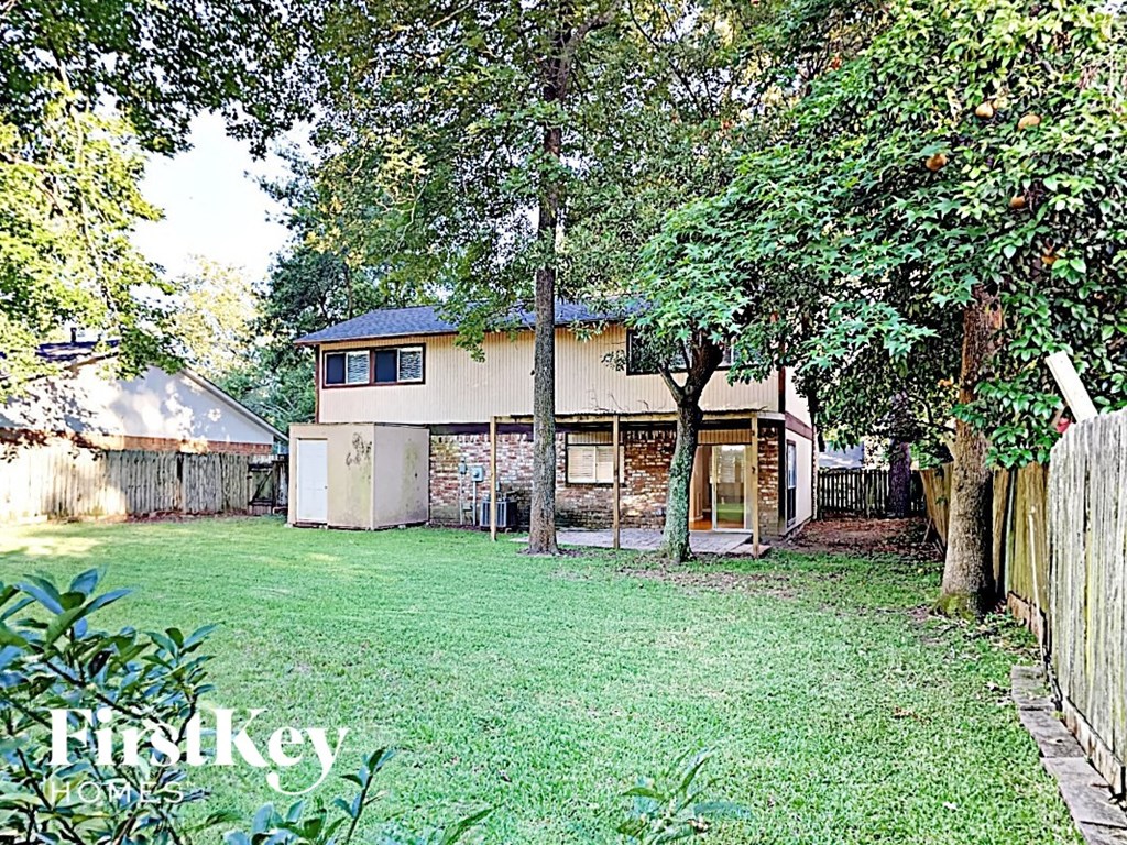 a backyard with a house and a yard and trees