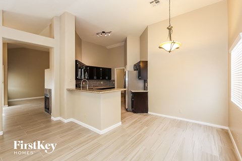 an open kitchen and living room with a wood floor