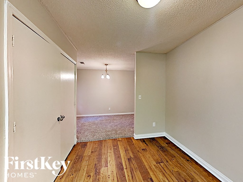 A room with wooden floors and a white door.