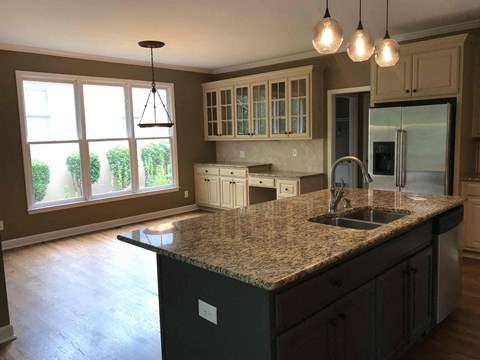A kitchen with granite countertops and a sink.