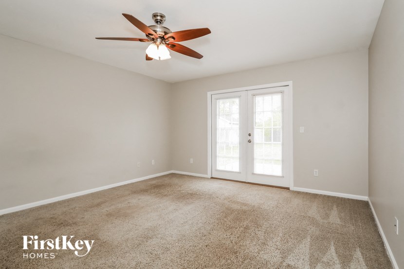 the master bedroom is spacious and has a ceiling fan
