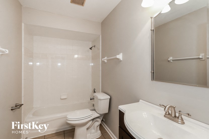 a bathroom with a sink toilet and a tub and a mirror