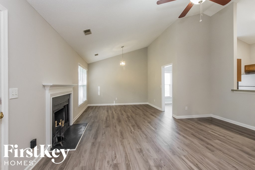 the living room with fireplace and hardwood flooring