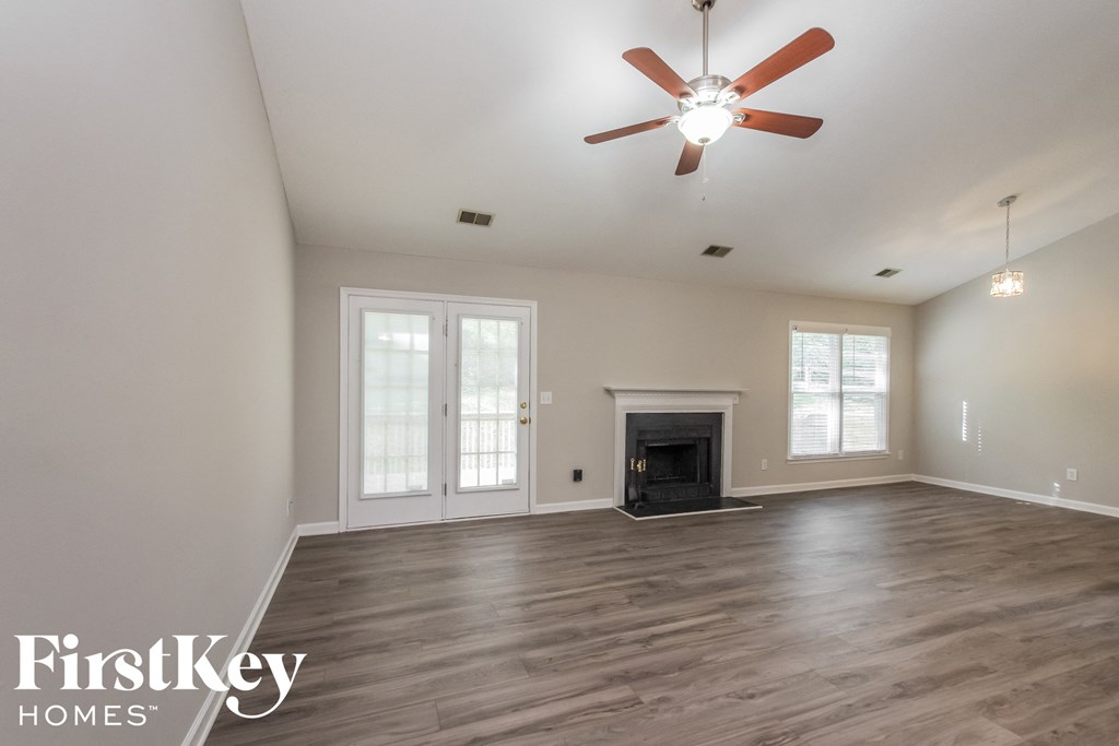 the living room has a fireplace and hardwood floors