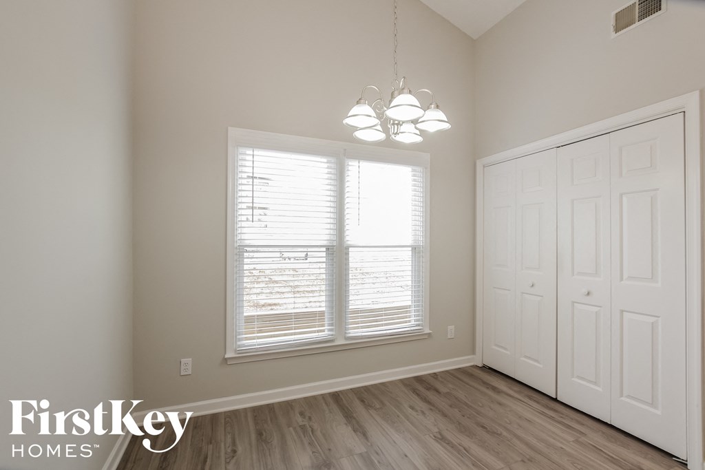 a bedroom with a large window and a white door