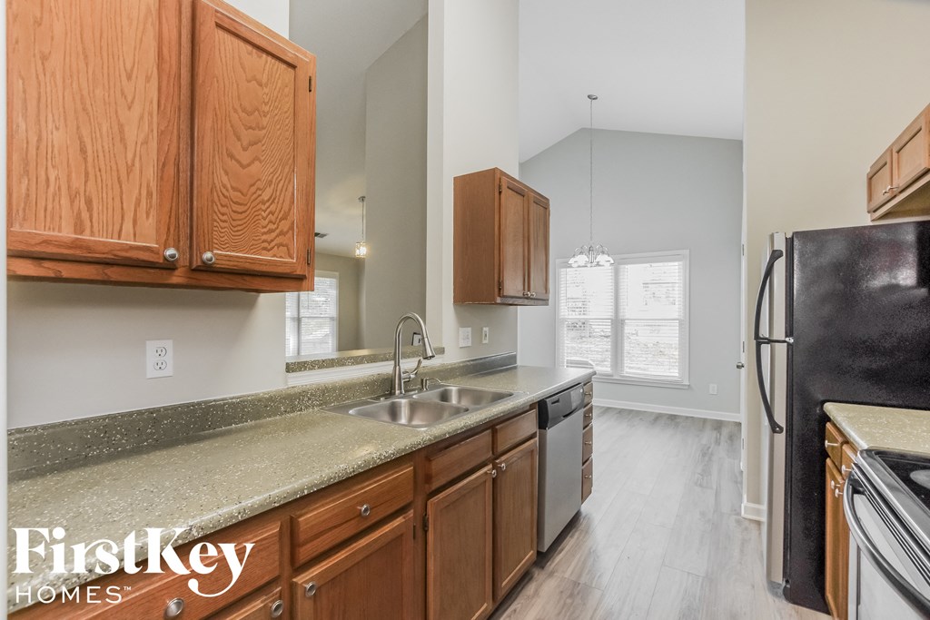 a kitchen with wood cabinets and granite counter tops and a sink