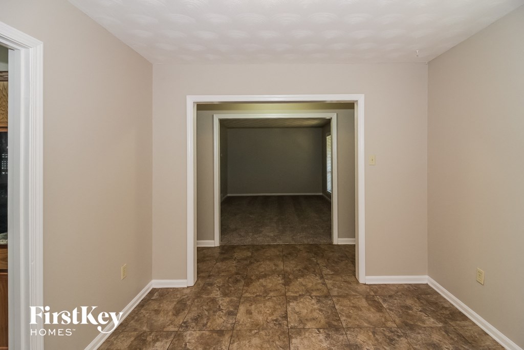 a room with a hallway and a door to a closet