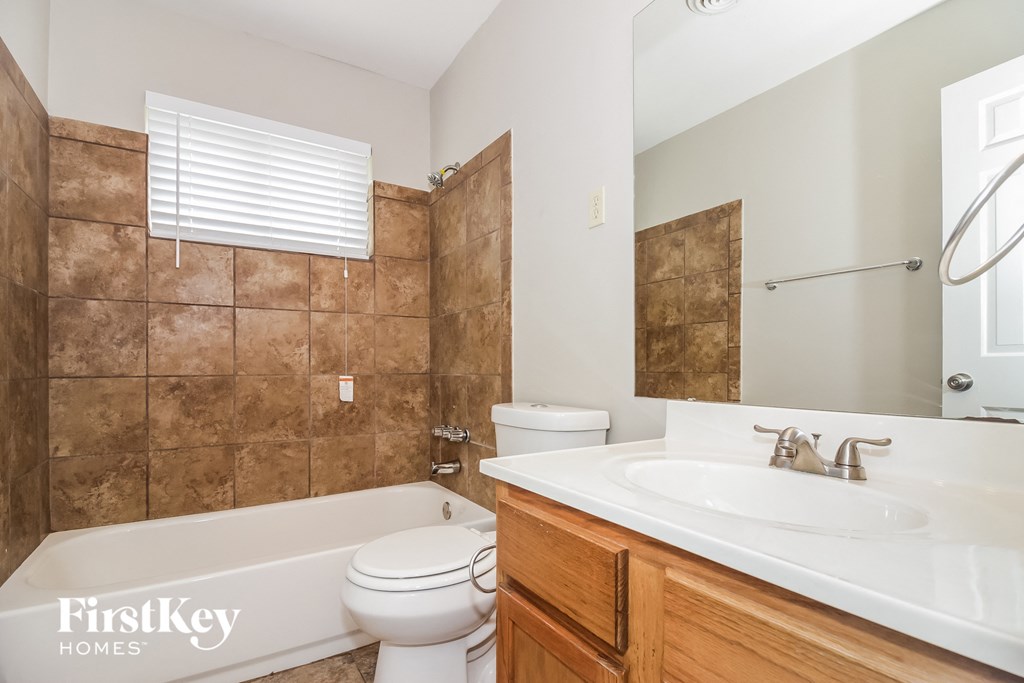 a bathroom with a sink toilet and a bath tub