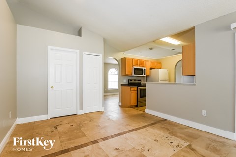 A kitchen area with a microwave and oven built into the cabinetry.