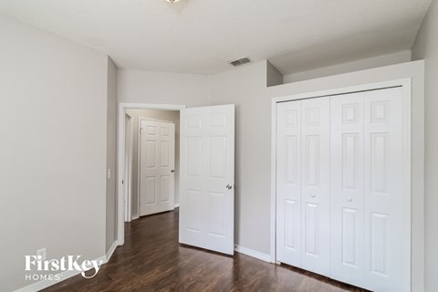 a bedroom with two closets and a door to a hallway