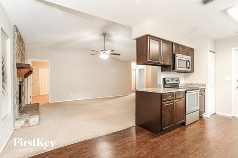 A kitchen with a stove top oven and a microwave above it.