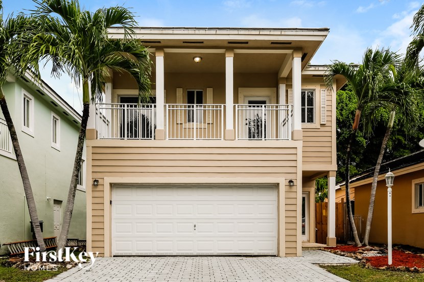A two-story house with a balcony and a garage.