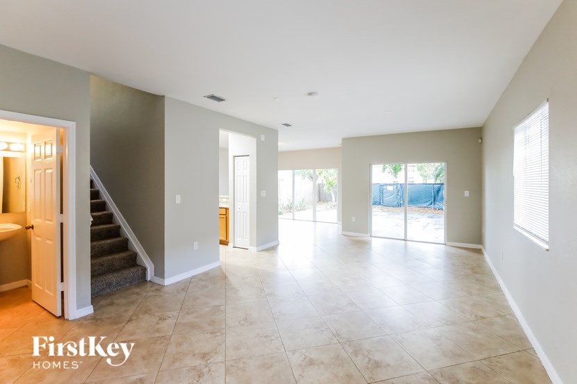 A spacious room with a staircase leading to the upper floor.