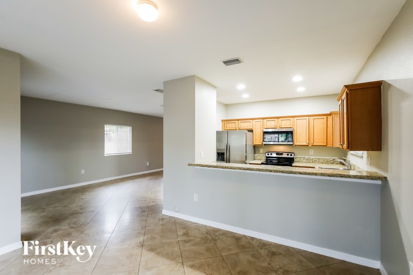 A kitchen area with a countertop and cabinets is shown.