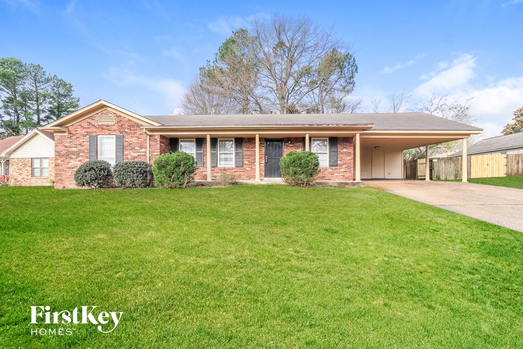 a brick house with a lawn in front of it