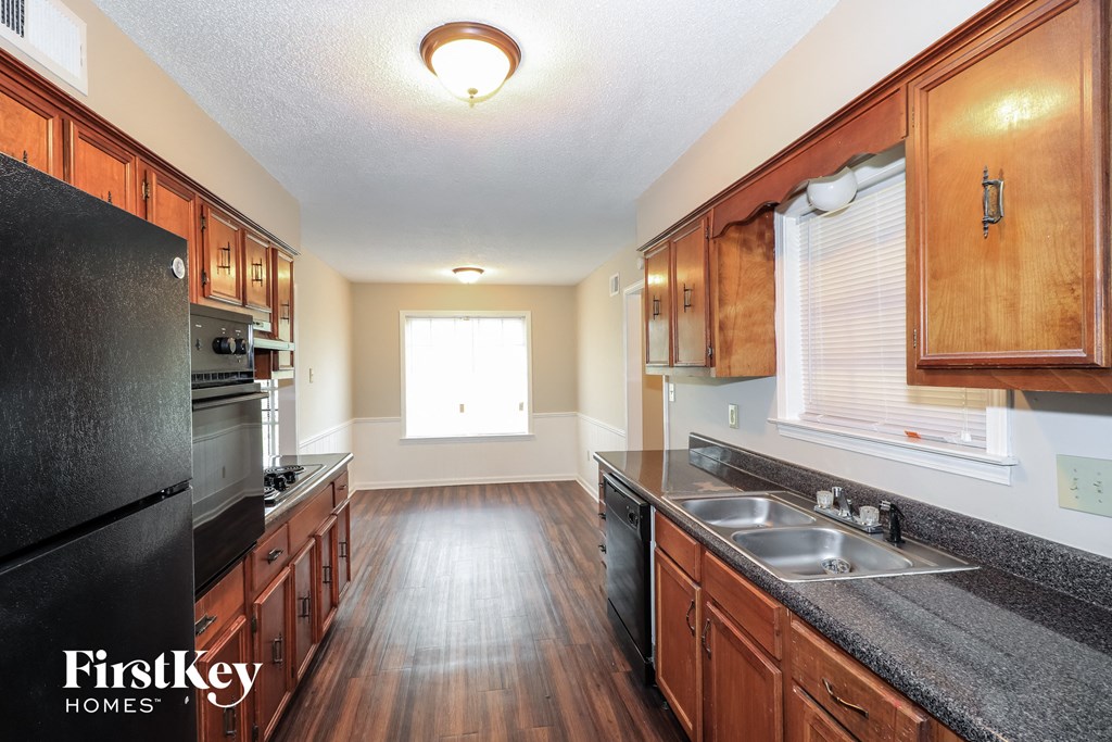 a kitchen with wood flooring and granite counter tops