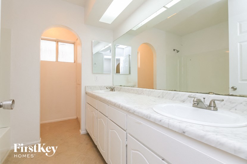 a bathroom with a sink and a large mirror