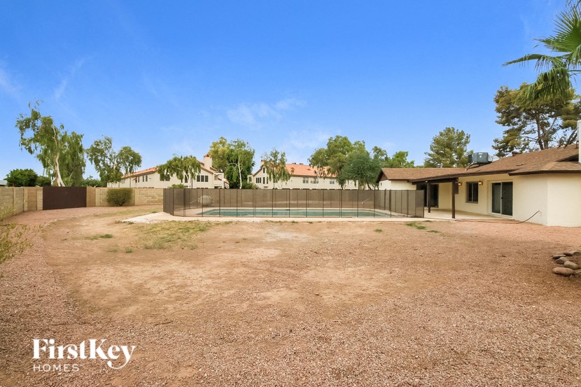 a backyard with a tennis court and a house