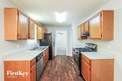 A kitchen with wooden cabinets and black appliances.