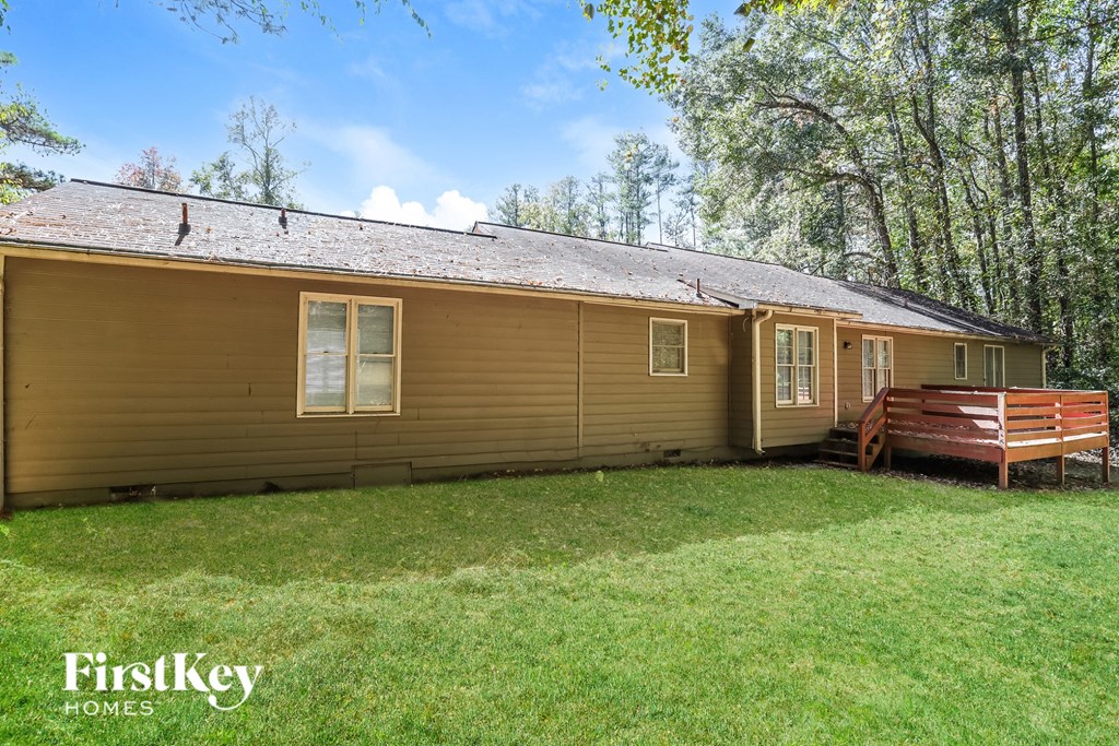 A house with a brown siding and a brown deck.