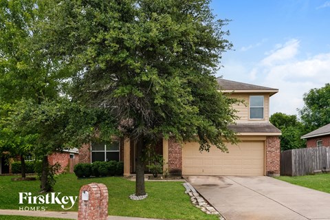 A house with a tree in front of it.
