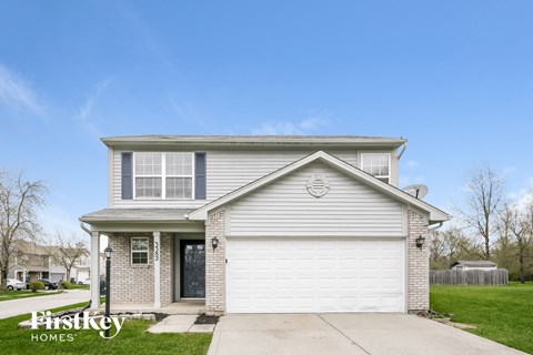 a white house with a blue sky behind it
