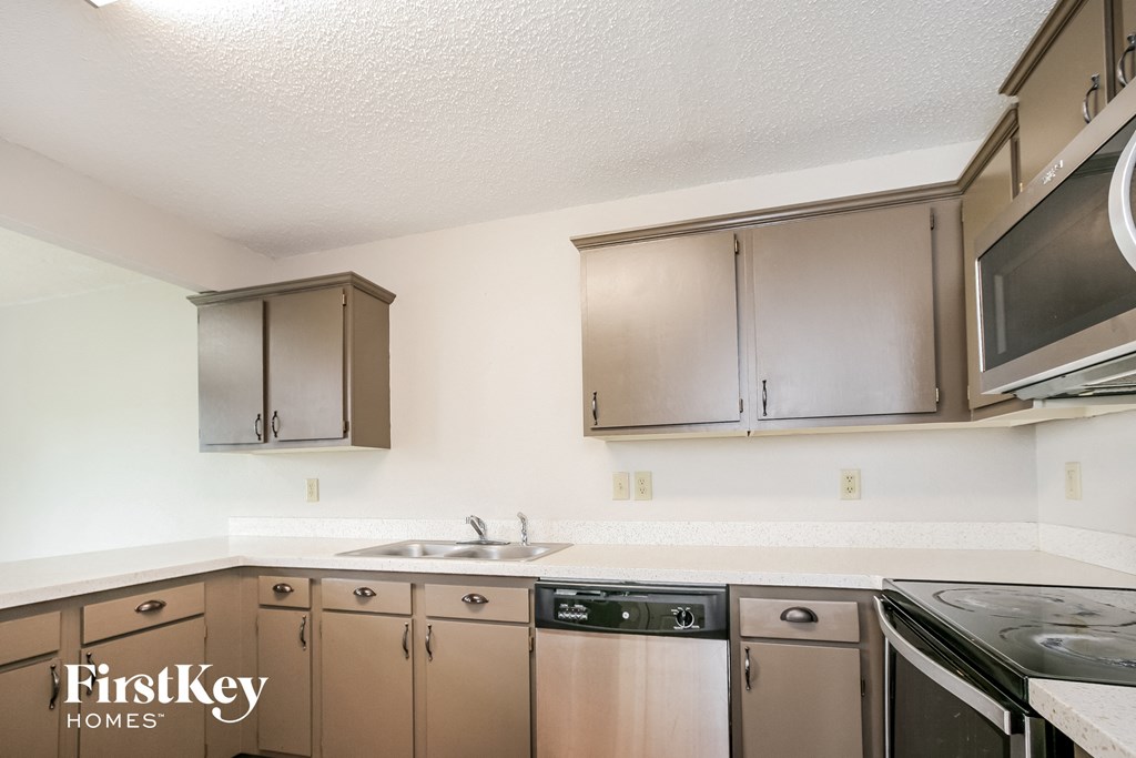 a kitchen with stainless steel appliances and wooden cabinets