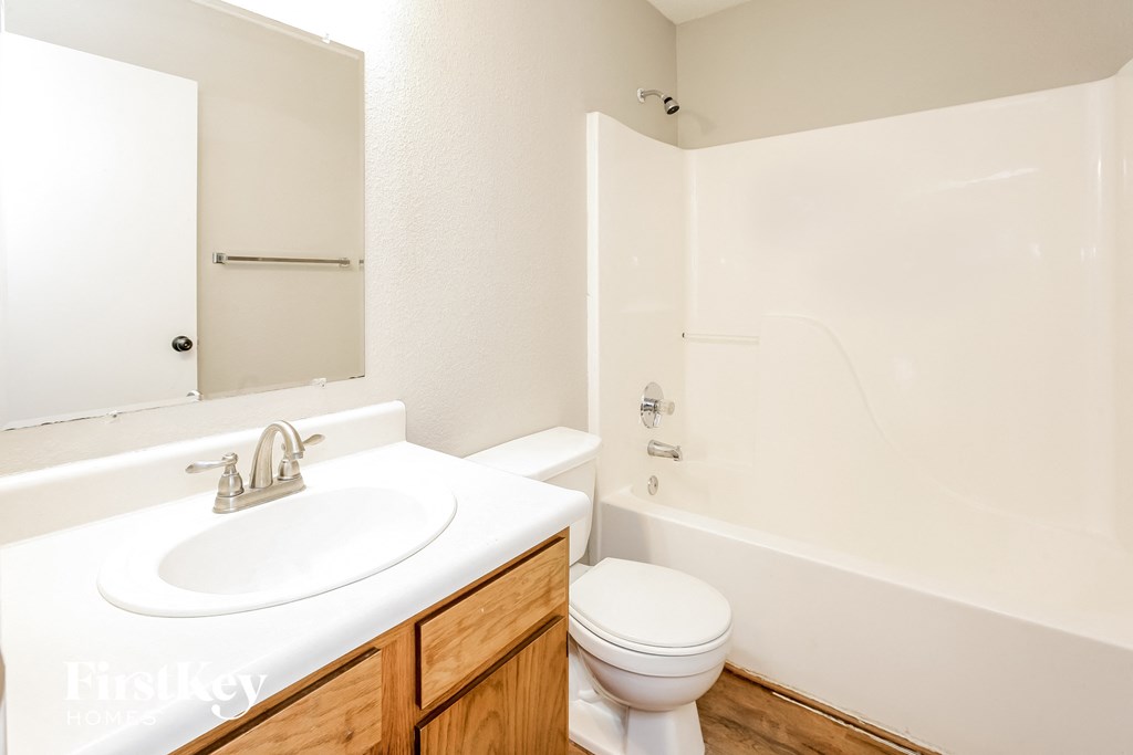 a bathroom with a sink toilet and a tub
