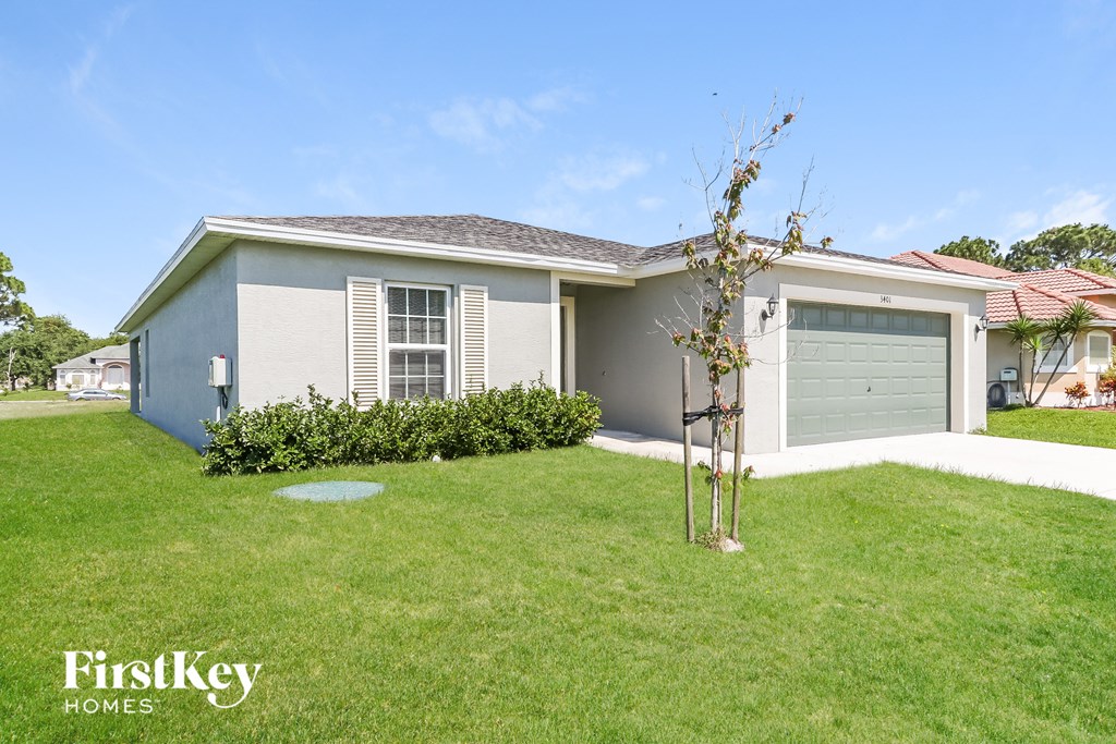 a home with a lawn and a garage