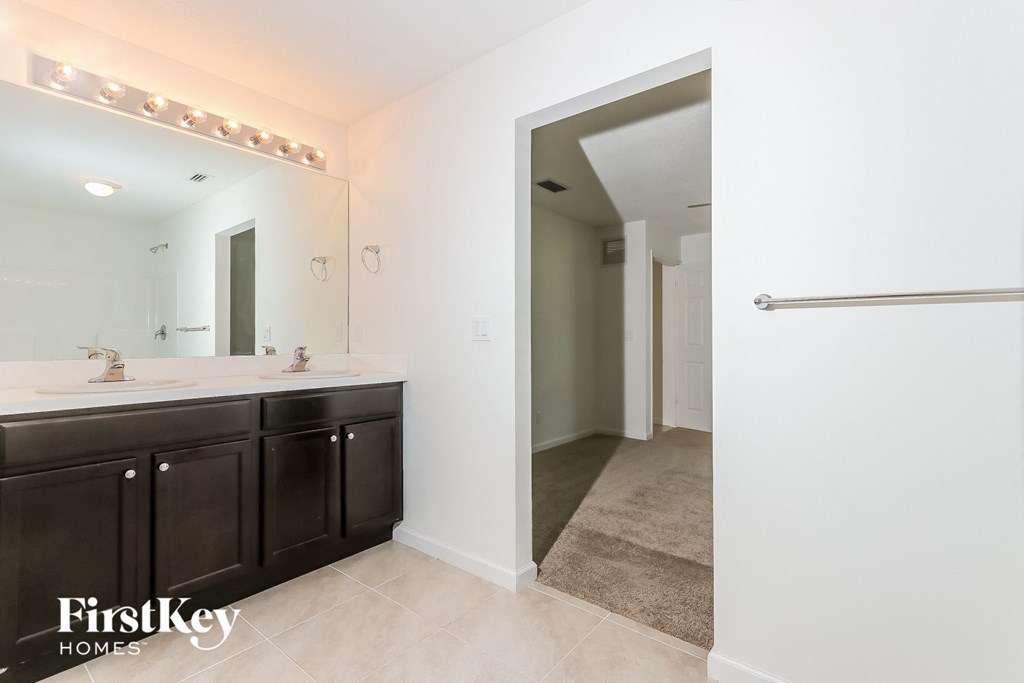 a bathroom with two sinks and a large mirror