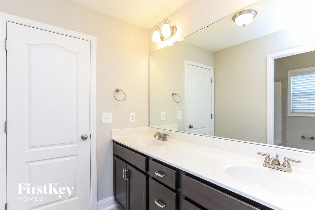 a bathroom with two sinks and a large mirror