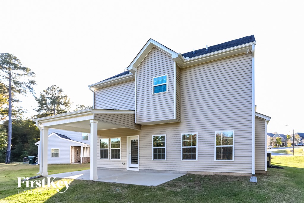 the front of the house is shown with a porch and garage