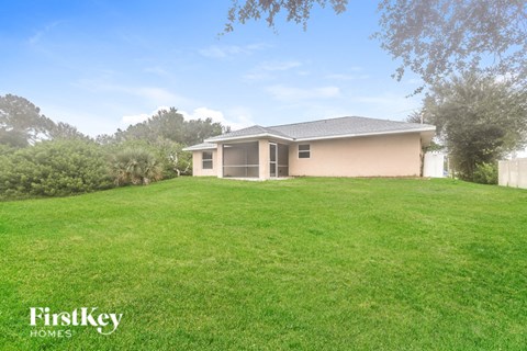 a house on a hill with a grassy yard
