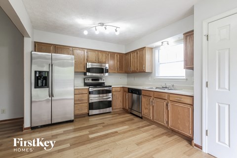 A kitchen with wooden cabinets and stainless steel appliances.