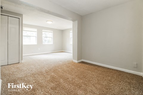 a bedroom with a white door and a carpeted floor