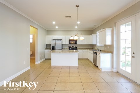 A spacious kitchen with a large island in the middle.